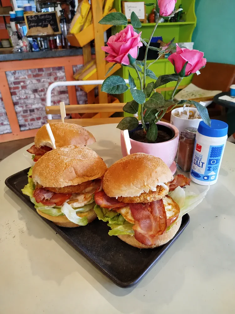 Bacon and egg sliders served with a pink rose